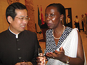 Chinese Ambassador to Rwanda, Sun Shuzhong chats with Minister of Information Louise Mushikiwabo over dinner during the Chinese anniversary. (Photo/ E. Kwibuka)