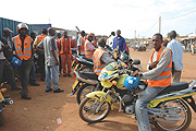 Motorcyclists wait for passengers. Some in the transport service sector have maintained fares regardless of a drop in fuel prices.