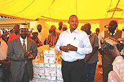 MTNu2019s John Bosco Sendahangarwa (R) hands foodstuffs to the Muslim Community in Nyamirambo while Mufti Saleh Nsabimana claps in appreciation. (Photo/ G.Anyango)