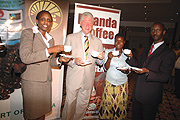 Bill Clinton (C) with the State Minister of Agriculture, Agnes Kalibata (L) taste the aroma of Rwanda Coffee. (File photo)