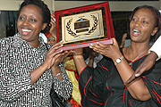 KCC Mayor, Aisa Kirabo Kacyira  and KCC Vice Mayor in charge of Finance and Administration, Jeanne du2019Arc Gakuba show off UN-Habitat award at the Airport. (Photo / G.Barya)