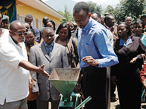 President Kagame being shown some of the money making projects of COPAQUE Rugerero yesterday. (PPU Photo)