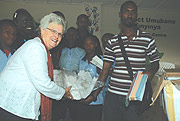 Jill Fenton the Executive  Director of Green Hills Academy hands over the donations to the Kinyinya orphans. (Photo/ G.Barya).