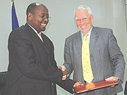 Finance Minister James Musoni and Head of EU Commission to Rwanda, David MacRae shake hands after signing MoU.  (Photo/ J Mbanda).