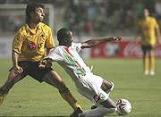 Omonoia Nicosiau2019s Hamad Ndikumana(R) battles AEKu2019s Ignacio Martin Scocco during a UEFA Cup tie. The Amavubi star will decide his future after 2010.