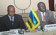 AU's Maxwell Mkwezalamba (L)  and Justice Minister Tharcisse Karugarama attending an AU meeting.
