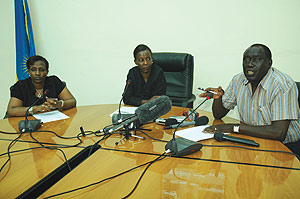 Justice Minister Tharcisse Karugarama (R)  responds to questions from journalists as Ministers Louise Mushikiwabo (C) and Rosemary Museminali look on. (Photo/J. Mbanda)