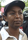 Aloysia Inyumba yesterday braved the rain to show her solidarity with Rose Kabuye. (Photo/ G.Barya).
