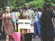 People in Rwanda march in protest against Rose Kabuyeu2019s arrest in Germany.