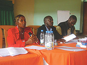 Goreth Mukandoli addresses participants as Richard Kananga of NURC and Aimable Nsenzimana of NYC listen (Photo/ R.Mugabe)