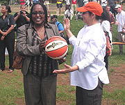 AKWOS president Felicite Rwemalika receives part of the sports consignment from CARE global ambassador Sheila Johnson.