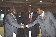 Mwai Kibaki, shakes hands with Uhuru Kenyatta, Kenyau2019s Deputy prime minister and minister for trade as Robert Bayigamba looks on. (Photo/ G. Barya).