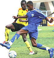 Amavubiu2019s Patrick Mafisango battles with Ugandau2019s Vincent Kayinzi  during last yearu2019s semifinal meeting between the two sides.