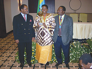 NURC Executive Secretary, Fatuma Ndangiza (C) admires award flanked by the Commissionu2019s President,Jean Baptist Habyarimana (R) and Ambassador Mussie Hailu. (Photo/ R.Mugabe)