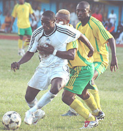 THE BALL IS MINE:  APRu2019s Kabange Twite beats off a challenge by Atracou2019s defender Amoroso last season. APR won yesterdayu2019s league match 3-1 at Amahoro stadium. (File photo).