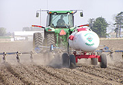 A farmer applying  fertilizers.