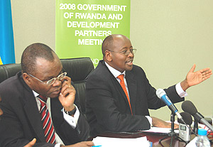 Minister of Finance, James Musoni stressing a point at a press conference while UN Resindent Coordinator, Aurelien Agbenonci, listens. (Photo/G.Barya).