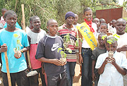 Akazuba posses for a photo with the pupils of the Nkundabana orphanage school before planting the trees. (Photo / J. Mbanda).