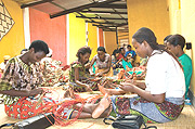 Rwandan women weaving baskets.