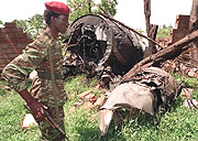 A soldier walks by the wreckage of the plane carrying President Habyarimana.