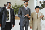 President Paul Kagame (C) after being briefed by EAC Secretary General Amb. Juma Mwapachu. Left is Eriya Kategaya of Uganda (File photo)