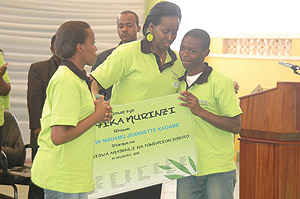 First Lady Jeannette Kagame receiving an appreciation certificate from children who benefit from the organisation she created, Imbuto Foundation. (Photo/ G. Barya)