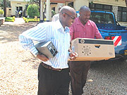  The Director of SOS Children Village Alfred Munyantwali (L) carries away his computer. (Photo/ J Mbanda)