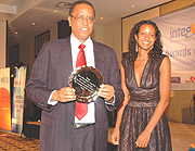 Prof. Silas Lwakabamba, NUR Rector displays a trophy during the RITA Intego awards recently. A similary event to be held by PSF early next year. (File photo)