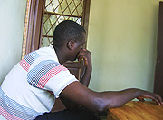 Justin Mutabazi shying away from the camera at Remera police station on Monday. (Photo/ E Mutara)