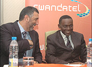 Abdulbaset Elazzabi, the Chairman, Board of Directors of Rwandatel and ICT Minister, Romain Murenzi. (File photo)