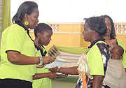 Jeannette Kagame handing over the Malayika Murinzi during the closing of Imbuto Foundation  Youth forum at  Remera Stadium. (Photo / G. Barya)