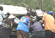 Speed kills: Local rescue team helping the injured and removing dead bodies from a taxi wreckage.