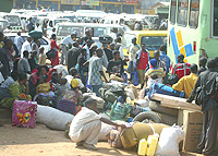 TIME TO GO HOME : People stranded at Nyabugogo main taxi park on their way home for Christmas. (Photo/ G.Barya)