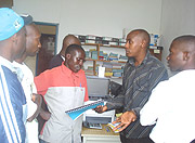 Vivens Ukubaho(2nd right), the district tax official explains to motocylists about the taxes.  (Photo / D.Sabiiti)