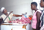 A Lady buys meat at Kimironko market Yesterday. (Photo/ G.Barya)