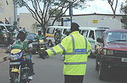 A Police man directs motocycles during the Road safety week that preceded Christmas. (Photo/ G.Barya).