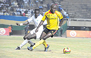 Ugandau2019s Egyptian based professional Geoffrey Massa tries to dribble past a Rwandau2019s Alou Gasueka. Uganda will play Kenya in the 2009 Cecafa senior finals (Photo / A. E. ORYADA)