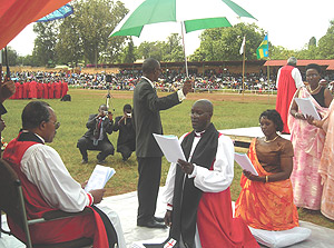Rt Reverend Gasatura (kneeling) takes his Vows before Arch-Bishop Emmanuel Kolini(seated) in Huye on Sunday. (Photo/ P Ntambara).