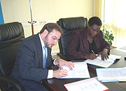 Minister Daphrose Gahakwa signs the MoU with GLP Programme Officer Steven Ehrenberg at MINEDUC offices yesterday. (Photo/ R Mugabe).