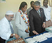 UTEXRWA Managing Director Raj- Rajendran (2nd right) explains to the Kigali City Vice Mayor Jeanne du2019Arc Gakuba how silk worms produce thread. (Photo J Mbanda)