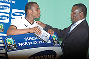 YOU WERE OUTSTANDING: Ghanau2019s skipper Ayew Dede (L) receives the Samsung man of the match award from Cecafau2019s secretary general Nicolas Musonye (Photo / G. Barya)