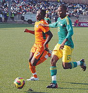 Tussling it out; South Africau2019s Matuka Thabang and Ivory Coastu2019s Nu2019gossan Antoine Jean battle for the ball in Yesterdayu2019s game. South Africa won 1-0. (Photo / G. Barya )