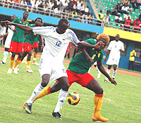 Yussuf Ndayishimiye beats Cameroonu2019s danger man Fomen Charley Roussel off the ball in yesterdayu2019s game.  The ended in1-all draw.  (Photo / G. Barya)