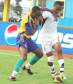 Rwandau2019s Jean Claude Iranzi challenges Ghanau2019s Ayew Dede for the ball in yesterdayu2019s game. Ghana won 2-0. (Photo: G. Barya).
