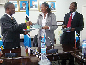 Linda Bihire (centre),  Dr. Shukuru Jumanne Kawambwa (left) and Philippe Njoni (right) exchange the signed MoU in Arusha, Tanzania. (Courtsey Photo)