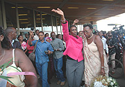 Rose Kabuye waves at Rwandans who had througed the airport to welcome her home on Chistmas Eve. (File photo).
