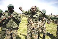 A member of the rebel CNDP puts on a government army uniform on January 29 afyter the group agrred to lay down arms and join the government.