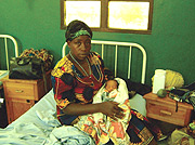 Nyiramana cuddling her baby in Gisenyi Hospital following her evacuation from the DRC jungles. (Photo Byline).
