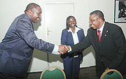 Ugandan State Minister of Tourism Serapio Rukundo (L) shakes hands with DR Congo Administrator for Nature Conservation Cosma Wilungula as Commerce Minister Minique Nsanzabaganwa looks on. (Photo/J Mbanda).