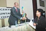 Auditor General Evlyne Kamagaju extends a token of appreciation to Finance Minister James Musoni for supporting ICPAR. (Photo J. Mbanda).
